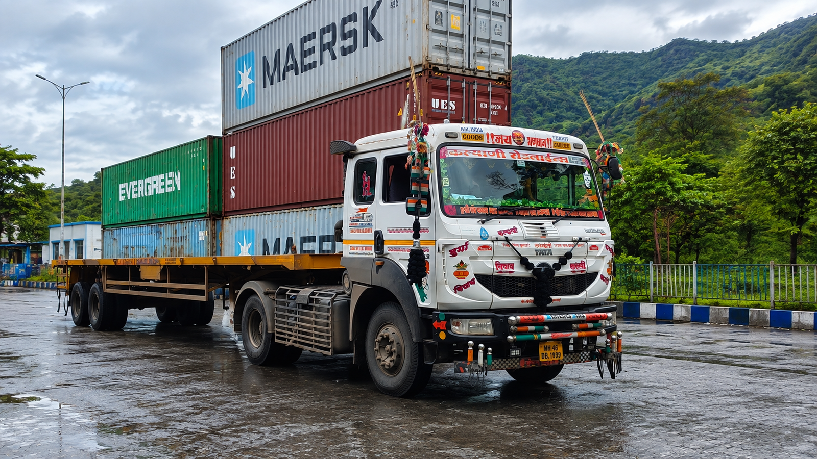 Stacked shipping containers on a Kalyani Roadlines truck